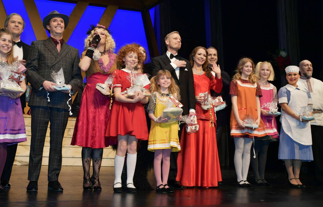 Anna Sahlin [röd klänning, sjätte från vänster i bild] och dottern Lily Wahlsteen [röd klänning, femte från höger i bild] spelade mot varandra i musikalen Annie år 2019.