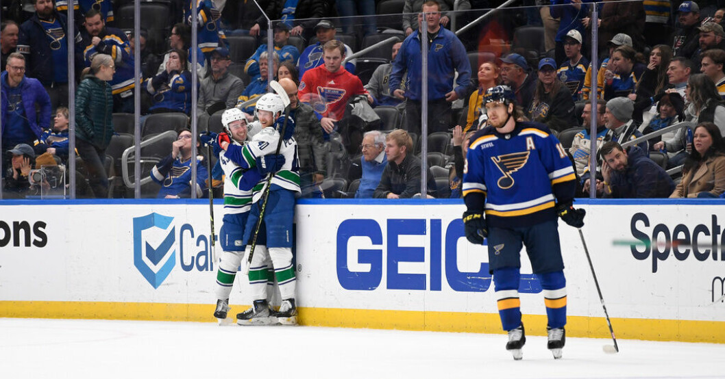 Elias Pettersson, i mitten, kramas om av lagkamraten Quinn Hughes efter sitt segermål i förlängningen mot St Louis. Glödhet Pettersson bakom Vancouvers vändning
