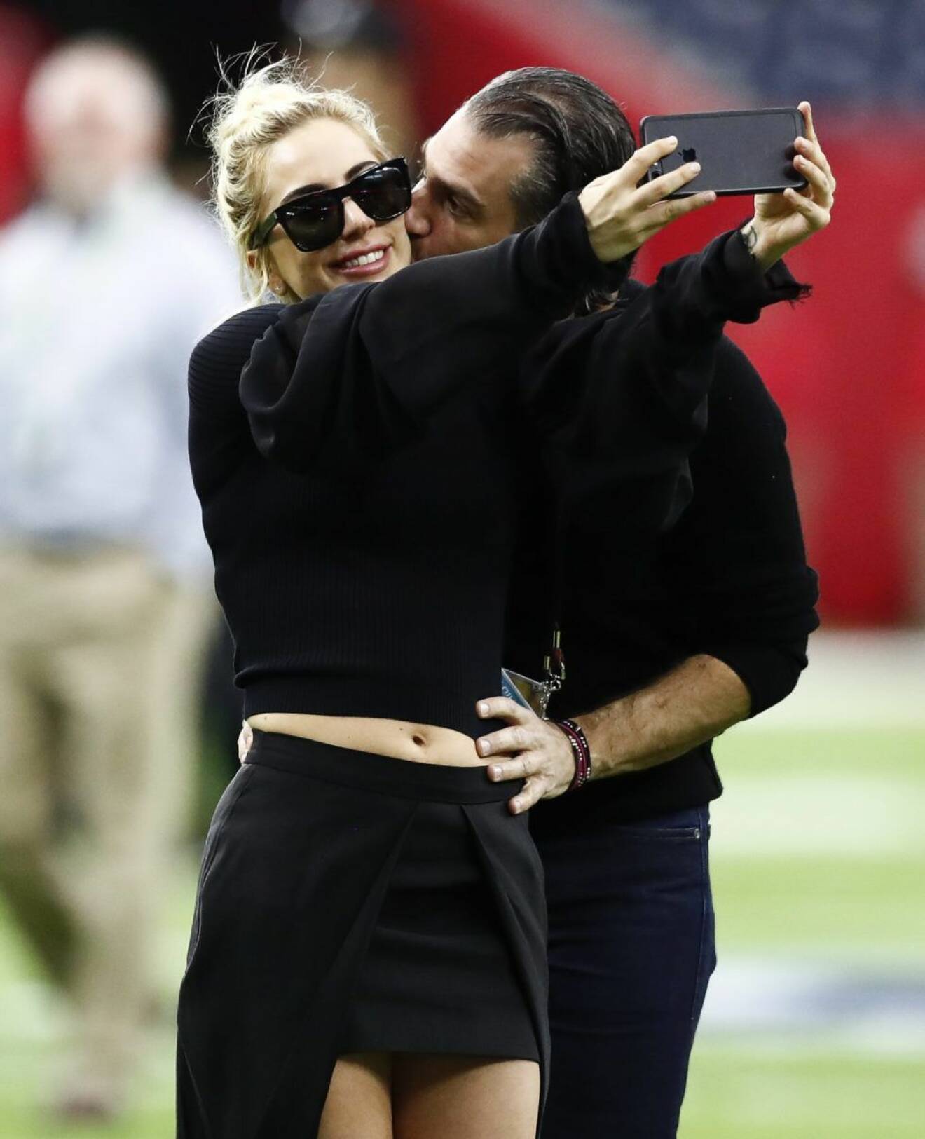 epaselect epa05773578 US singer Lady Gaga (L) takes a selfie with agent Christian Carino before the start of Super Bowl LI at NRG Stadium in Houston, Texas, USA, 05 February 2017. Lady Gaga is the Halftime Show performer. The AFC Champion Patriots play the NFC Champion Atlanta Falcons in the National Football League's annual championship game. EPA/LARRY W. SMITH