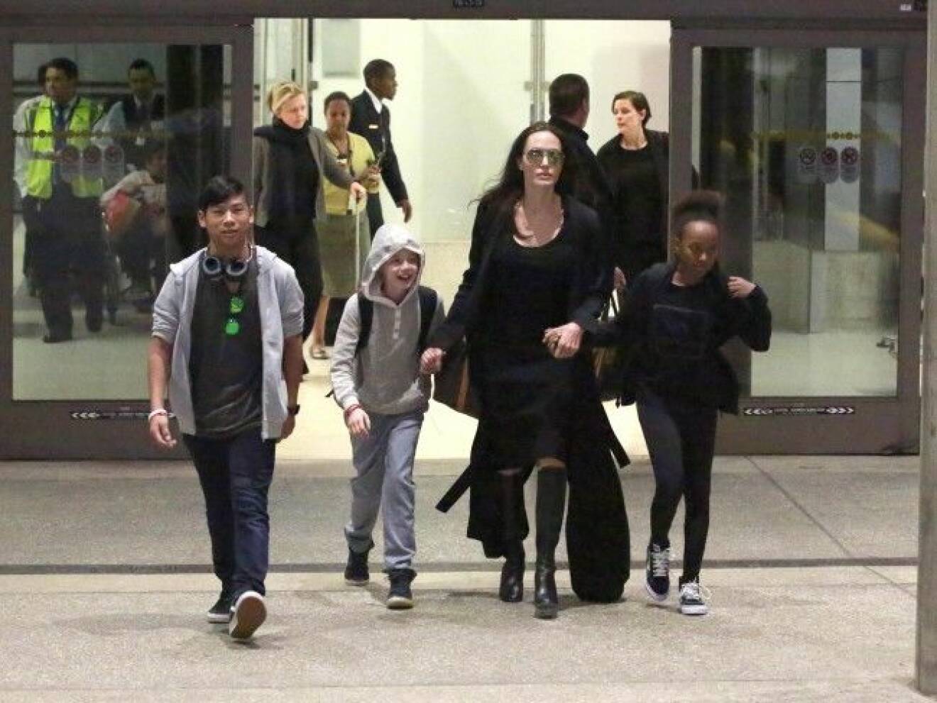 Angelina Jolie and her children arrive in Los Angeles. Jolie was seen with her kids, Shiloh, Maddox & Zahara. Jolie was seen in the center holding hands with Zahara & Shiloh as Maddox independently walked ahead. Pictured: Angelina Jolie, Shiloh Jolie-Pitt, Maddox Jolie-Pitt, Zahara Jolie-Pitt Ref: SPL1239691 020316 Picture by: Sharky / Splash News Splash News and Pictures Los Angeles:310-821-2666 New York: 212-619-2666 London: 870-934-2666 photodesk@splashnews.com *** Local Caption *** 8.18251239