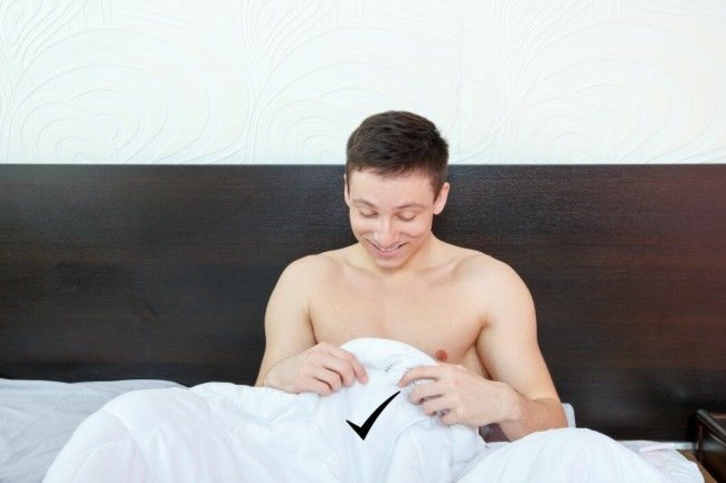 Foto: Colourbox Handsome satisfied man sure in himself showing under cover in bedroom strong penis erection in the morning . Photo of healthy male potency