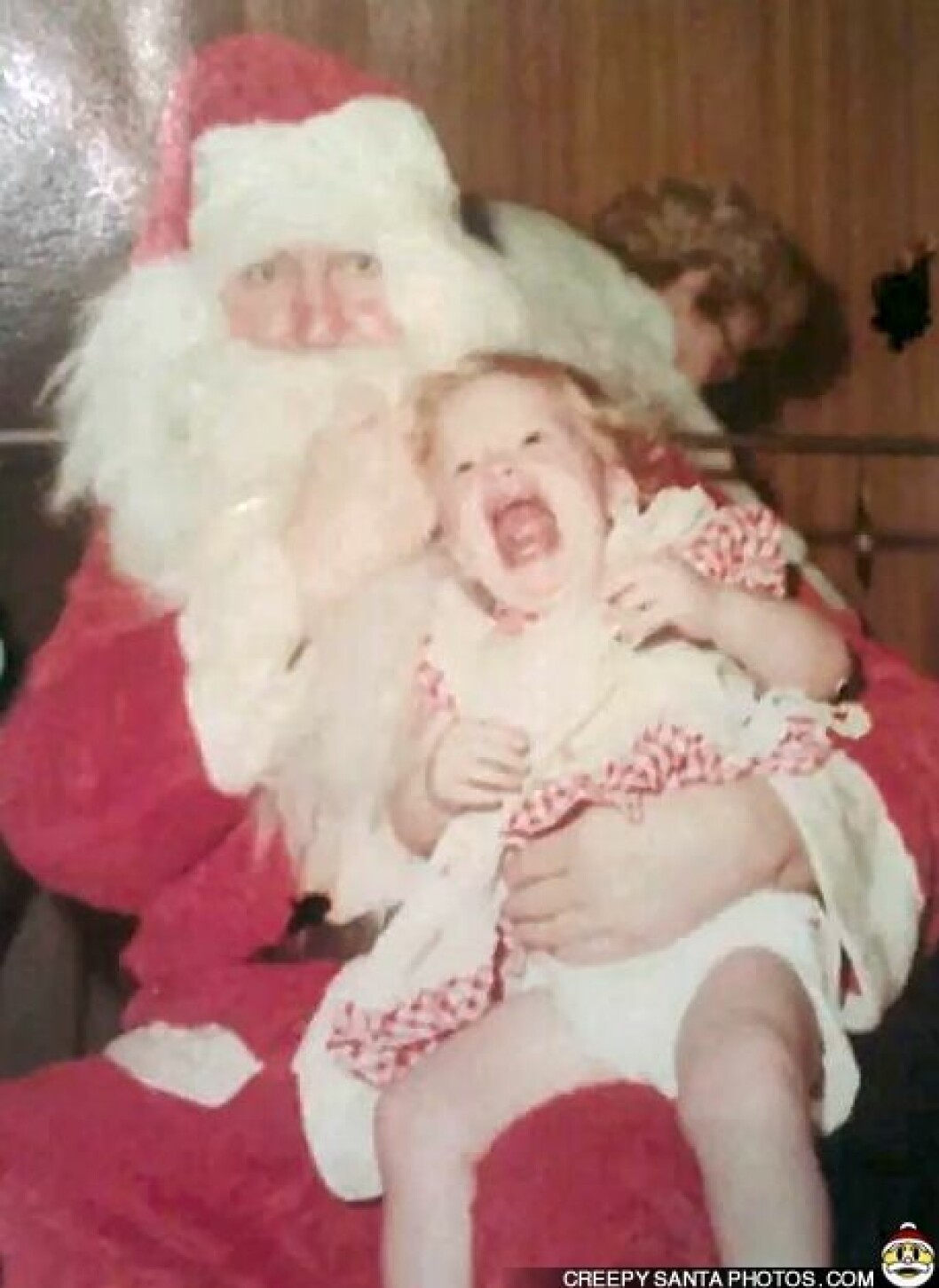 Via: <a href="http://www.creepysantaphotos.com/" target="_blank">Creepy Santa Photos</a> santa-punches-girl