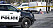 Gärningsmannens vita skåpbil och polisbil.