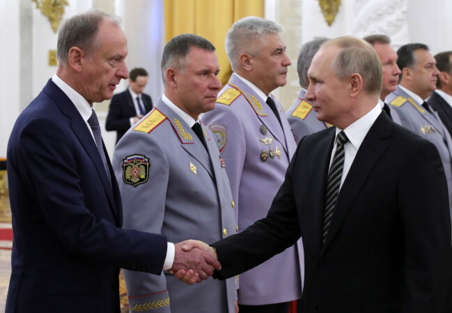 Nikolaj Patrusjev skakar hand med Vladimir Putin.