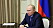 Vladimir Putin vid ett bord.