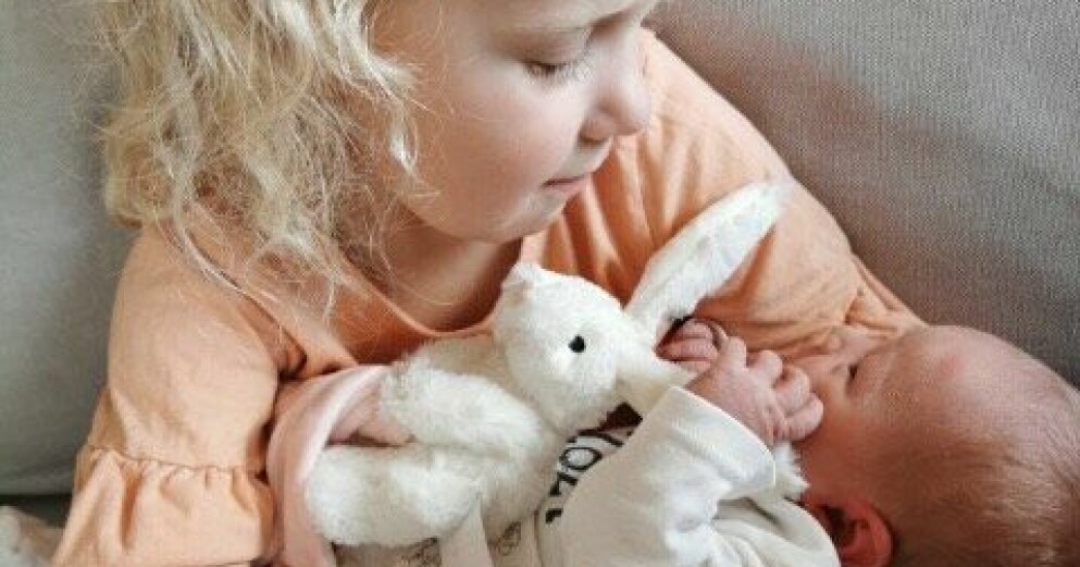 Ellen, 4, håller sin lillasyster Julia i famnen. Ellen och Julia
