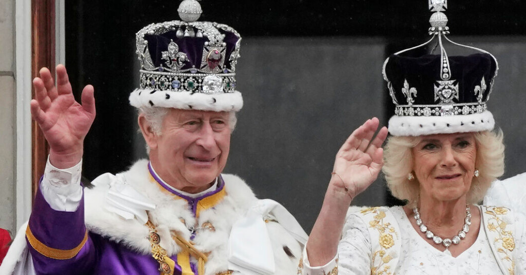 Storbritanniens nykrönte kung Charles och drottning Camilla vinkar till folkhavet framför Buckingham Palace efter att kröningsceremonierna är avklarade. Nykrönta paret tackar från berömda balkongen