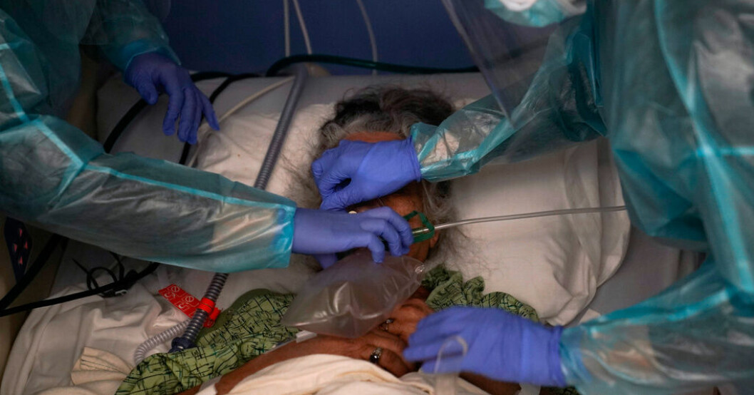Två sjuksköterskor hjälper en covidpatient på S:t Josephs Hospital i Orange, Kalifornien. Bild från den 7 januari 2021. Johns Hopkins slutar covidrapportera